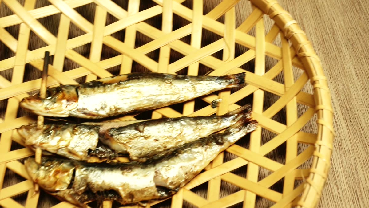ざるに並べた焼いた目刺しいわし