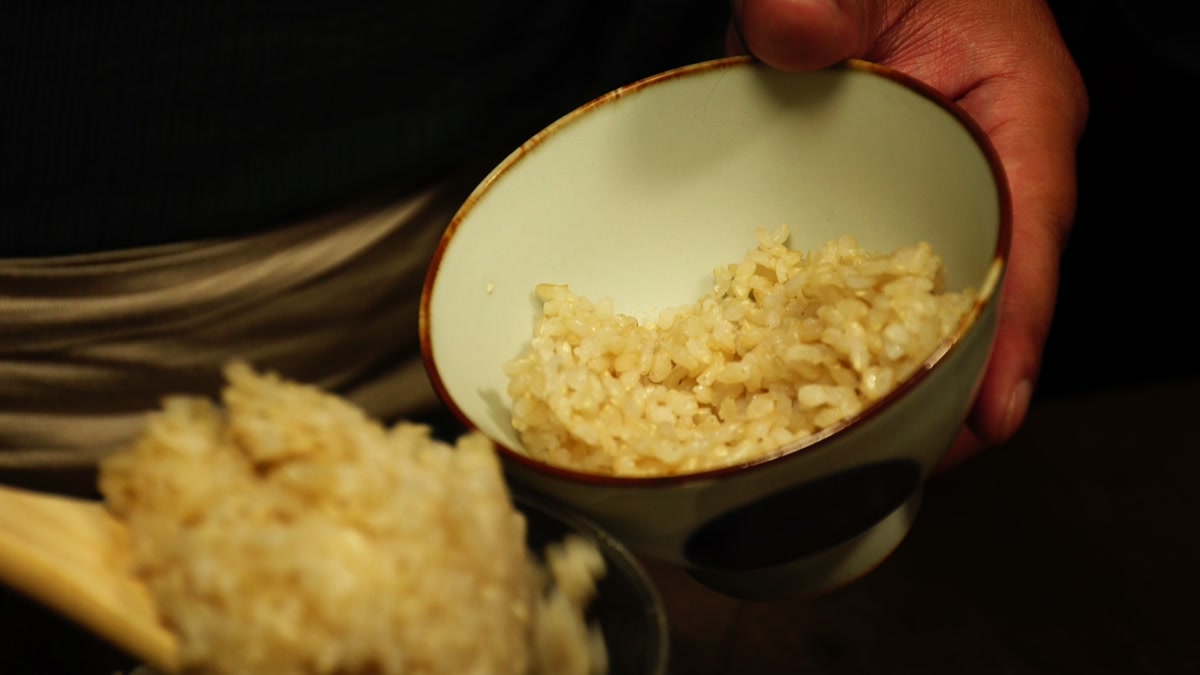 手に持った椀によそった玄米